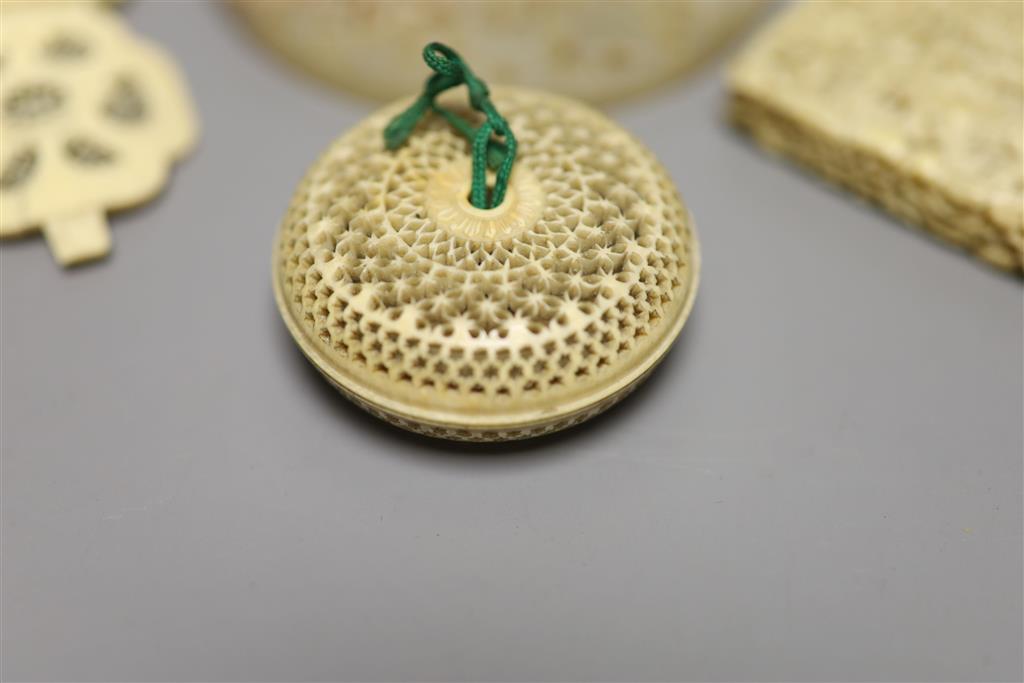 Three pieces of 19th century Chinese export carved ivory to include a card case, a pomander and a decorative panel, together with a car